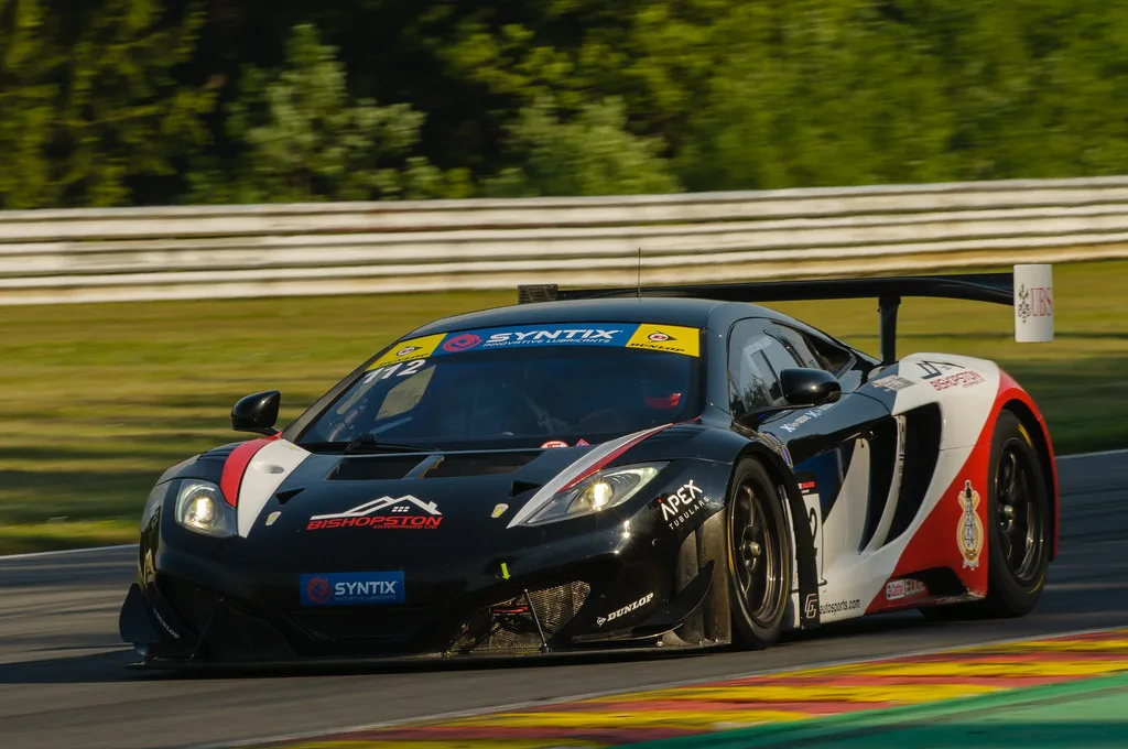 McLaren GT-raceauto op het circuit van Spa-Francorchamps met de karakteristieke gekleurde kerbstones